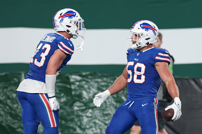 Bernard and Milano celebrate a big play during the season-opener against the New York Jets on Sept. 11.